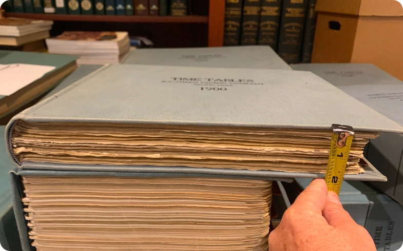 1900 Southern Pacific timetable volume measured before archival digitization at California State Library